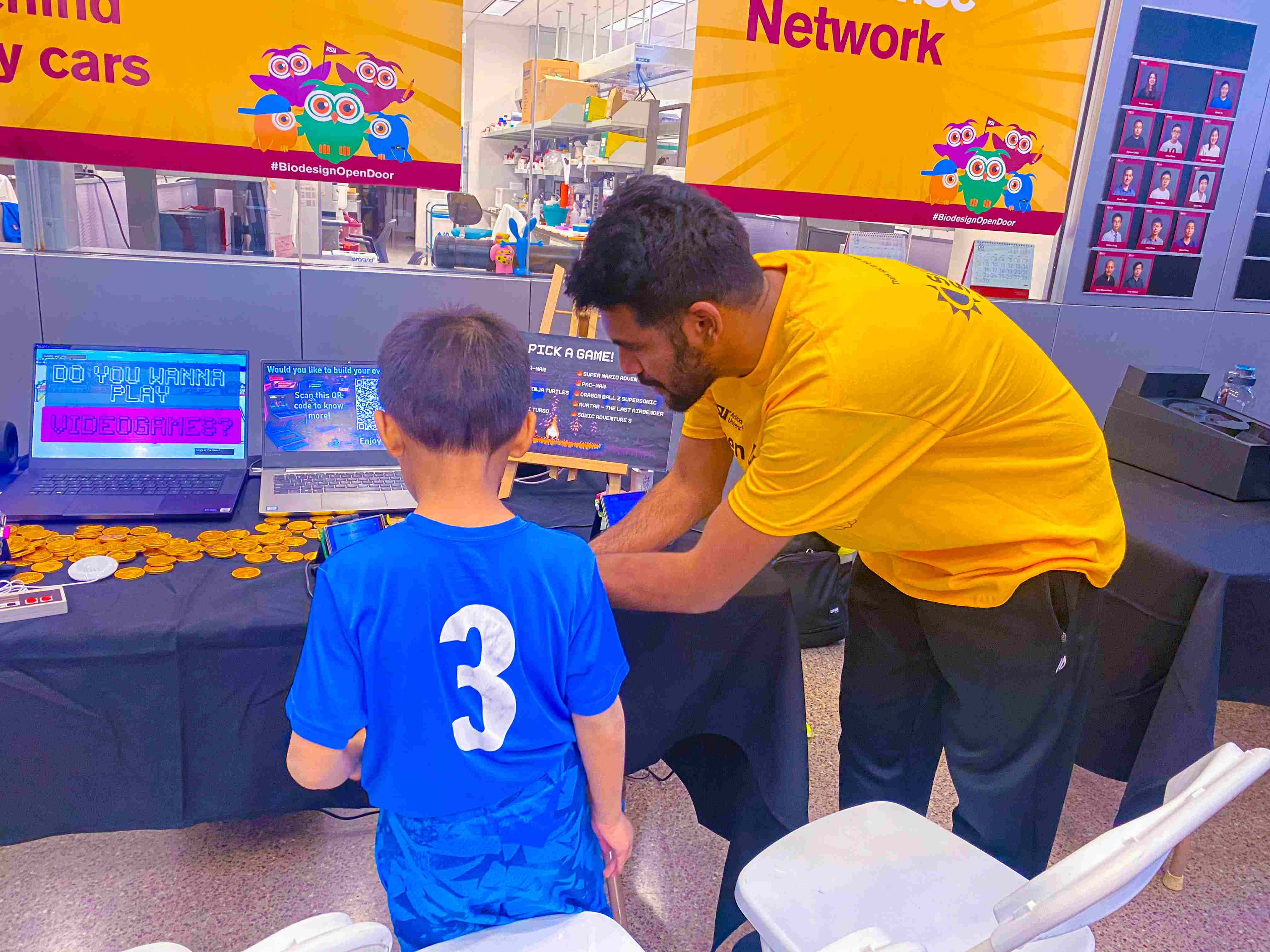 Adi helping a kid play one of the from-scratch builds at ASU Open Door