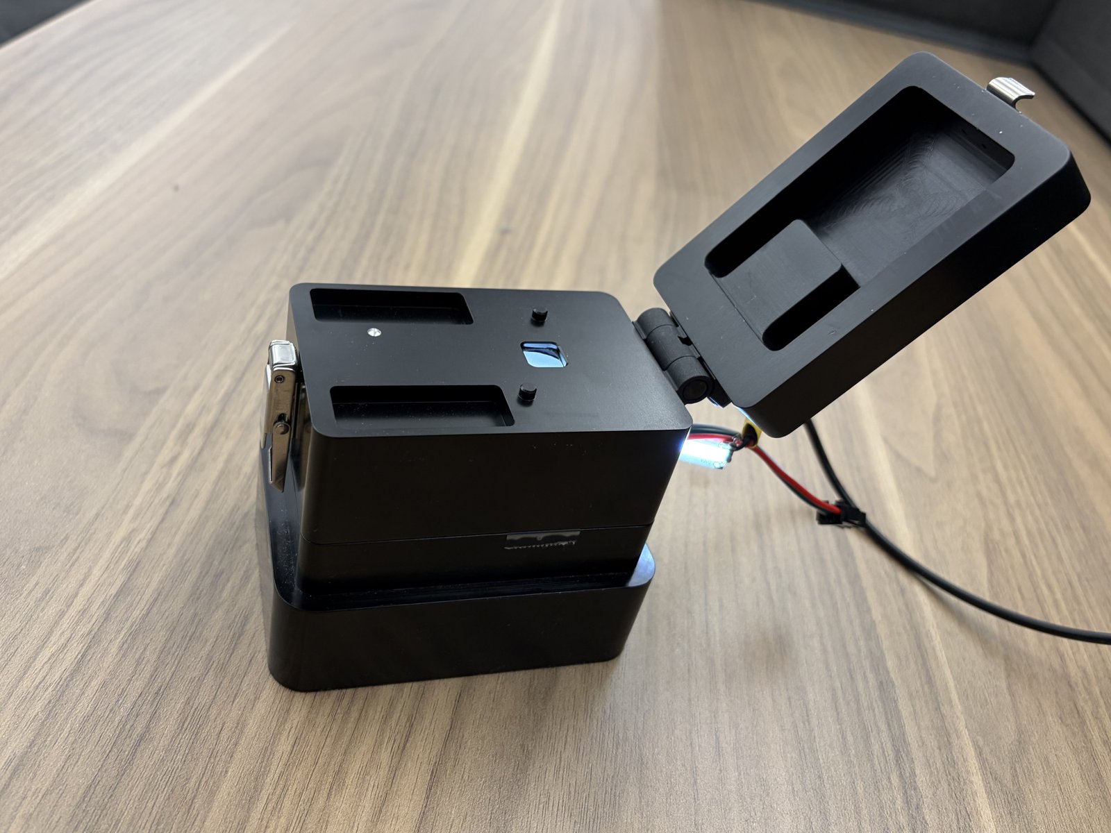 PCB QC fixture with lid open showing internal camera and lighting